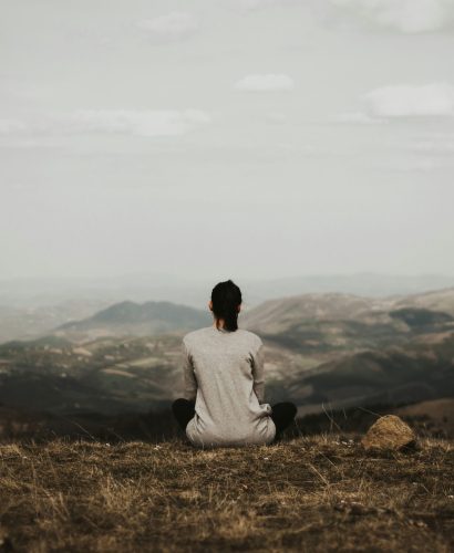 Woman sitting looking at mountains Woman sitting looking at mountains